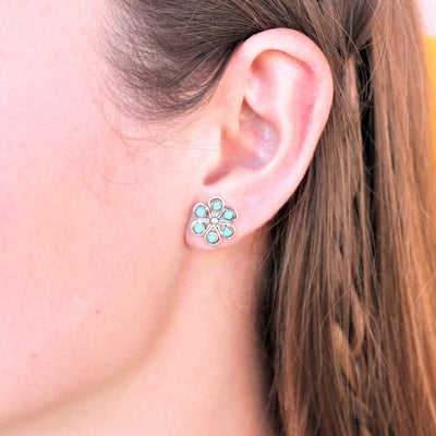 woman wearing turqoise flower and sterling silver earrings - coco and duckie